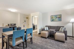 a living room with a table and chairs and a couch at Franklin Extended Stay Hotel in Franklin