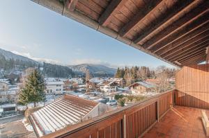 a balcony with a view of a town in the snow at Ferienwohnung "Freihauswinkl" in Bad Wiessee