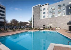 a large swimming pool in front of a building at Hyatt House San Jose Airport in San Jose