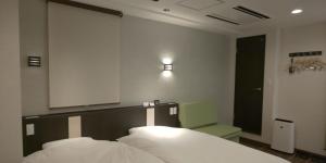 Postel nebo postele na pokoji v ubytování Ueno First City Hotel