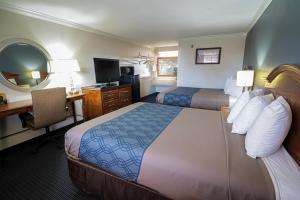 A bed or beds in a room at University Inn & Suites