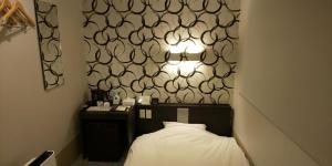 Postel nebo postele na pokoji v ubytování Ueno First City Hotel