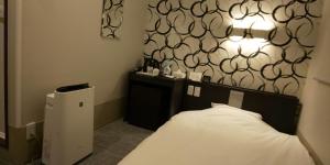 Postel nebo postele na pokoji v ubytování Ueno First City Hotel