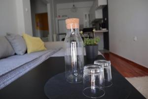 a glass bottle with a cork on top of a table at Black & Yellow Apartment at City Center in Ioannina