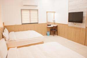 מיטה או מיטות בחדר ב-Yellow Mountain Homestay