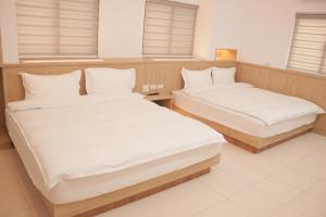 מיטה או מיטות בחדר ב-Yellow Mountain Homestay