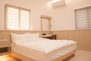 מיטה או מיטות בחדר ב-Yellow Mountain Homestay