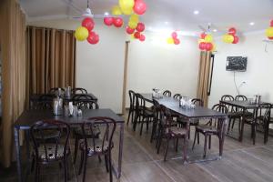a room with tables and chairs with balloons on the wall at HOTEL YOG TAPOVAN- Rafting Available in Rishīkesh
