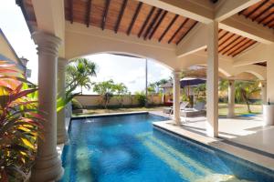 an outdoor swimming pool in a villa with a swimming pool at The Beverly Hills Bali Villas Resort in Jimbaran