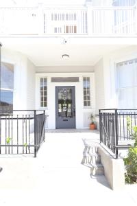 a white house with a black fence and a door at The Burlington in Los Angeles