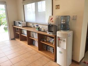 a kitchen with a counter and a refrigerator at Pine Shima Resort Coral Fish in Ibaruma