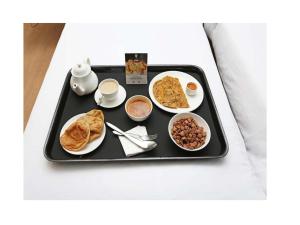 a tray of breakfast food on a table at ANH Hotel in Lucknow