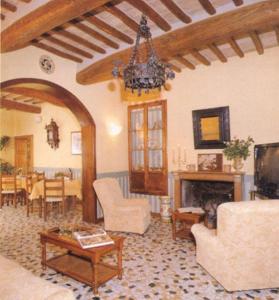 a living room with a fireplace and a table at Hotel Porziuncola in Assisi