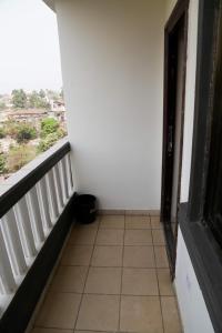 a room with a balcony with a tiled floor at HOTEL MALLIKA COMPANY, SL in Freetown