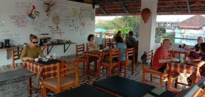 a group of people sitting at tables in a restaurant at La Lune Fort Kochi in Cochin