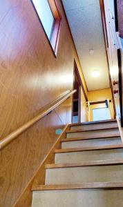 a set of stairs in a building with a window at B&B MIKAWA 3 - Kanazawa Fish Harbour in Kanazawa