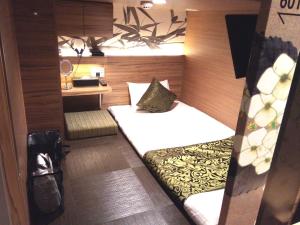 a small bedroom with a bed in a room at HOTEL Cargo Shinsaibashi in Osaka