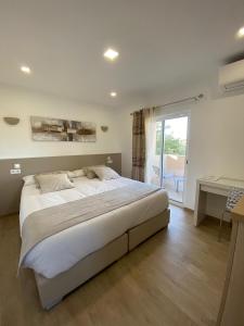 a bedroom with a large bed and a balcony at VILLA L'ESTAQUE in Armação de Pêra +67 photos