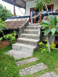 a set of stone stairs in front of a house at Bamboo Bali in Amed