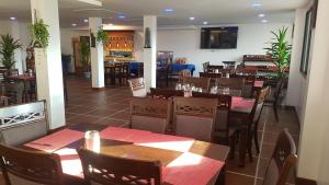 a dining room with tables and chairs in a restaurant at La Capannina Hotel Patong in Patong Beach