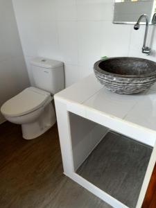 a bathroom with a sink and a toilet at Bamboo Bali in Amed