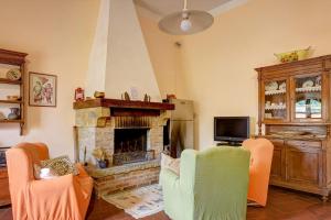 a living room with two chairs and a fireplace at Podere Fontecastello in Montepulciano