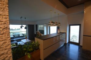 a kitchen with a counter and a living room at Juniper Apartment in Braşov