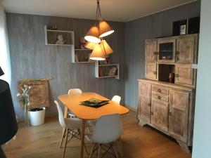 a dining room with a wooden table and chairs at Quatre à Metz in Metz
