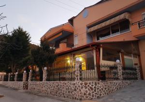 a building with a fence in front of it at Kohyli Apartments in Skala Rachoniou