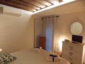a bedroom with a bed and a dresser and a window at La Casa di Sonia Apartment in Venice