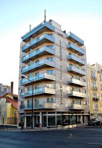a large apartment building on the corner of a street at Lisbon City Hotel by City Hotels in Lisbon