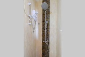 a bathroom with a shower with a shower head at Amaze Residence luxury 2 bedroom apartment 5 in Boralesgamuwa +47 photos