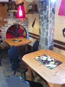 two tables and chairs in front of a brick oven at Apartma Miša in Prevalje