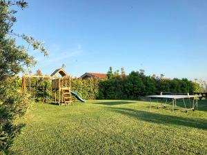 a large yard with a playground with a table and a bench at Agriturismo L'Antica Fornace in Peccioli