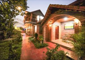 a brick house with a walkway in front of it at Ninh Binh Friendly Homestay in Ninh Binh