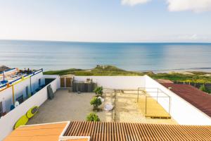 a view of the ocean from the roof of a house at SoulSurfcamp Portugal in Peniche