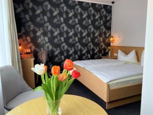 En eller flere senge i et værelse på Hotel-Restaurant Fuchs
