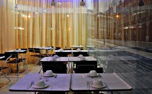 a dining room with tables with plates and utensils at Lisbon City Hotel by City Hotels in Lisbon