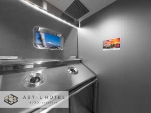 a kitchen with a stainless steel stove top oven at Astil Hotel Juso Precious in Osaka