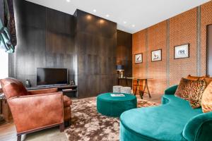 a living room with a couch and a tv at Cabosse, Boutique Palace & Spa in Antwerp