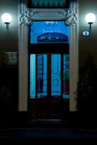 a front door of a building at night at Hotel Principi D'Acaja in Turin