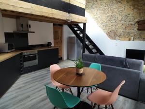 a kitchen and living room with a table and chairs at Wine Loft 66 in Baixas