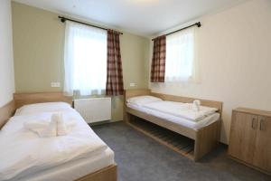 Posteľ alebo postele v izbe v ubytovaní Apartmány AURA