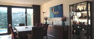 a dining room with a table and chairs and a window at Casa de Ribadouro in Baião