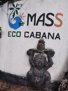 a sign that says mass ecoco cacizona next to a statue at Mass Eco Cabana Yoga & Spa - Unawatuna in Unawatuna