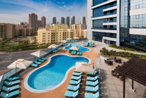 an overhead view of a pool on top of a building at Millennium Place Barsha Heights Hotel in Dubai