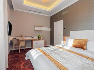 a bedroom with a bed and a desk in it at Pergola Boutique Hotel in Bucharest +54 photos