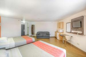 a hotel room with two beds and a flat screen tv at Motel 6-Regina, SK in Regina