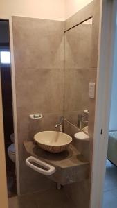 a bathroom with a bowl sink and a mirror at Los Franceses in San Rafael