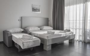 Postel nebo postele na pokoji v ubytování Whitehouse Apartments